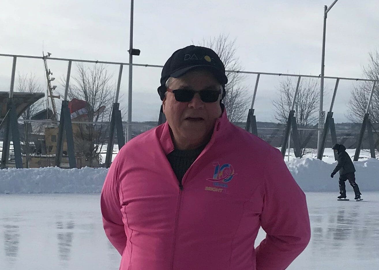 Photo of Mark skating in a black hat and pink BRIGHT Run sweater